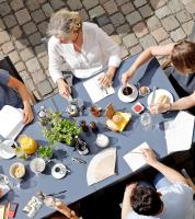 a group of people sitting around a table eating food at Altstadthof Freinsheim in Freinsheim