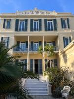 a large white building with a sign on it at Hotel Alexandra - Boutique Hotel in Juan-les-Pins