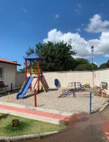 a playground with a slide and a play structure at Condomínio Residencial Mar Azul in Imbituba