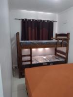 a room with two bunk beds and a window at Condomínio Residencial Mar Azul in Imbituba