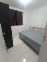 a bedroom with a bed and a window in a room at Condomínio Residencial Mar Azul in Imbituba