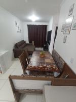 a living room with a table and a couch at Condomínio Residencial Mar Azul in Imbituba