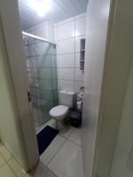 a small bathroom with a toilet and a shower at Condomínio Residencial Mar Azul in Imbituba