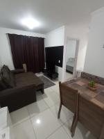 a living room with a couch and a table at Condomínio Residencial Mar Azul in Imbituba