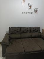 a brown couch sitting in a living room at Condomínio Residencial Mar Azul in Imbituba