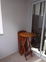 a small wooden table next to a window at Condomínio Residencial Mar Azul in Imbituba