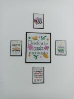 a wall with a picture of a collage of signs at Condomínio Residencial Mar Azul in Imbituba