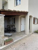 a patio with awning and a table in front of a house at Gîte des Restanques in Grasse