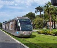 a silver train is on the grass in a park at Villa Serafina Apartements in Nice