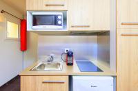 a small kitchen with a sink and a microwave at Villa Serafina Apartements in Nice