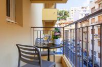 a balcony with a table and chairs and a window at Villa Serafina Apartements in Nice