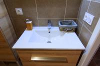 a bathroom with a white sink in a room at Villa Serafina Apartements in Nice