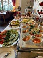 a buffet with many plates of food on a table at Burghaus & Villa Kronenburg in Kronenburg