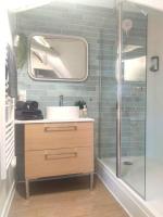a bathroom with a sink and a shower with a mirror at Equidia Compiègne Free Parking Wifi Self Check-in in Venette