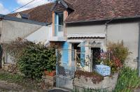 a house with a blue door and a fence at La Chaumière de Chaumont in Chaumont-sur-Loire