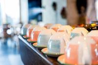 a line of plates and bowls sitting on a table at Sissi Park in Lachtal