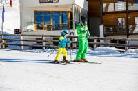 a man and a child on skis in the snow at Sissi Park in Lachtal