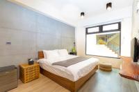 a bedroom with a bed and a large window at 日月潭山慕藝旅 Sun Moon Inn in Yuchi