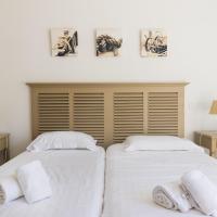 two beds sitting next to each other in a bedroom at Hotel et Studios Le Marina Baie de La Baule in Pornichet