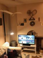 a living room with a flat screen tv on a table at La plage au bout du jardin &#47; Sword Beach cottage in Hermanville-sur-Mer