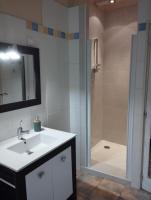 a bathroom with a sink and a shower with a mirror at Aux Berges du Canal in Capestang