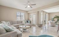 ein Wohnzimmer mit einer Couch und einem Tisch in der Unterkunft Stunning Ocean Breeze Luxury Villas 4D-Across The Street From The Ocean! Sleeps 10 guests! in Myrtle Beach