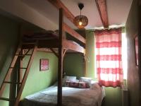 a bedroom with two bunk beds and a window at La Petite Finlande in Orbey