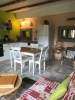 a kitchen and dining room with a table and chairs at La Petite Finlande in Orbey