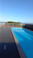 a swimming pool on the deck of a building at Condomínio Residencial Mar Azul in Imbituba