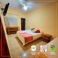 a bedroom with a bed and a flat screen tv at POUSADA VILA ACONCHEGO- Sossego- Em Meio Há Mata Nativa- by MARCOS MICOZZI in Serra do Cipo