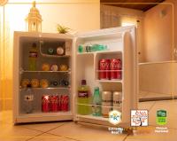 an open refrigerator filled with drinks and soda at POUSADA VILA ACONCHEGO- Sossego- Em Meio Há Mata Nativa- by MARCOS MICOZZI in Serra do Cipo