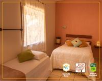 a bedroom with two beds and a window at POUSADA VILA ACONCHEGO- Sossego- Em Meio Há Mata Nativa- by MARCOS MICOZZI in Serra do Cipo