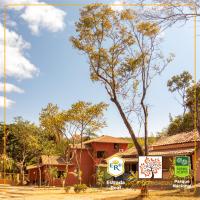 a sign in front of a building with a tree at POUSADA VILA ACONCHEGO- Sossego- Em Meio Há Mata Nativa- by MARCOS MICOZZI in Serra do Cipo