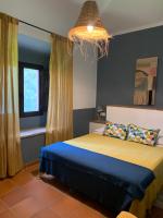 a bedroom with a bed with a blue and yellow blanket at Molino El Mastral in Tarifa