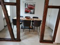 a dining room with a table and chairs and a mirror at Mosel Dream in Cochem