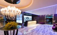 a hotel lobby with a chandelier and a table at FX Hotel Taipei Nanjing East Road Branch in Taipei