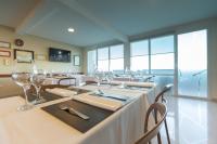 a dining room with a long table with wine glasses at ILLIA 121 APART HOTEL in Neuquén
