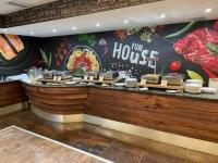 a fast food restaurant with a hog house sign on the wall at Franci Wellness Apartman Zalakaros in Zalakaros