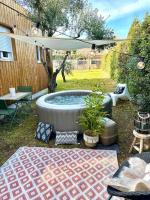 a patio with a hot tub in a yard at Studio provençal atypique avec jacuzzi privé in Sanary-sur-Mer
