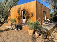 a wooden house with potted plants in front of it at Studio provençal atypique avec jacuzzi privé in Sanary-sur-Mer