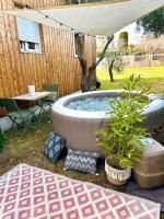 a hot tub in a yard with a table and chairs at Studio provençal atypique avec jacuzzi privé in Sanary-sur-Mer
