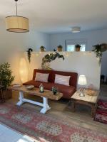 a living room with a couch and a table at Studio provençal atypique avec jacuzzi privé in Sanary-sur-Mer