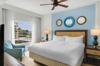 a bedroom with a bed and a chair and a window at Marriott&#39;s Legends Edge at Bay Point in Panama City Beach