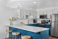 a kitchen with blue cabinets and a refrigerator at Marriott&#39;s Legends Edge at Bay Point in Panama City Beach