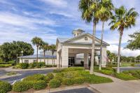 a house with palm trees in front of a street at Marriott&#39;s Legends Edge at Bay Point in Panama City Beach