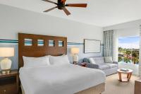 a bedroom with a bed and a couch and a window at Marriott&#39;s Legends Edge at Bay Point in Panama City Beach