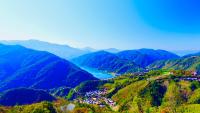 a valley in the mountains with a town on a hill at Junyi Landscape Villa in Ren&#39;ai