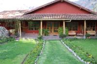 a house with a garden in front of it at Hotel Villa Urubamba in Urubamba