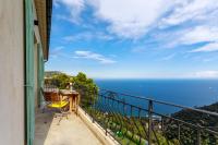 a balcony with a table and a view of the ocean at Sea terace apartment between Nice and Monaco - 3 in Villefranche-sur-Mer