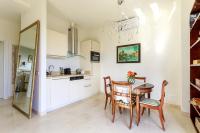a kitchen with a table and chairs and a mirror at Sea terace apartment between Nice and Monaco - 3 in Villefranche-sur-Mer